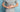 Man in grey t-shirt holding stomach in discomfort illustrating gut training for safe carb intake during running